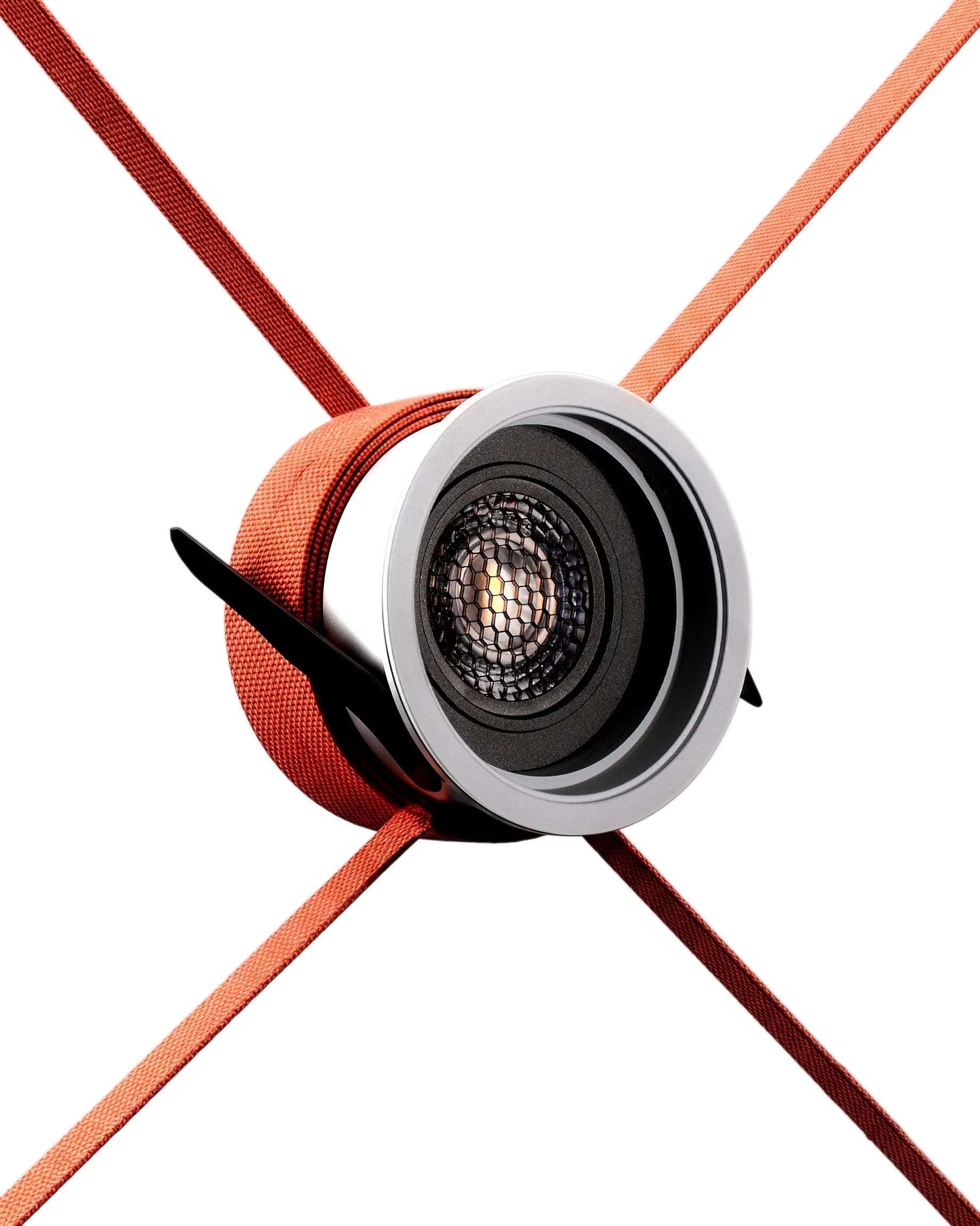 Lambent recessed downlight with honeycomb optic, suspended in a cross of orange straps