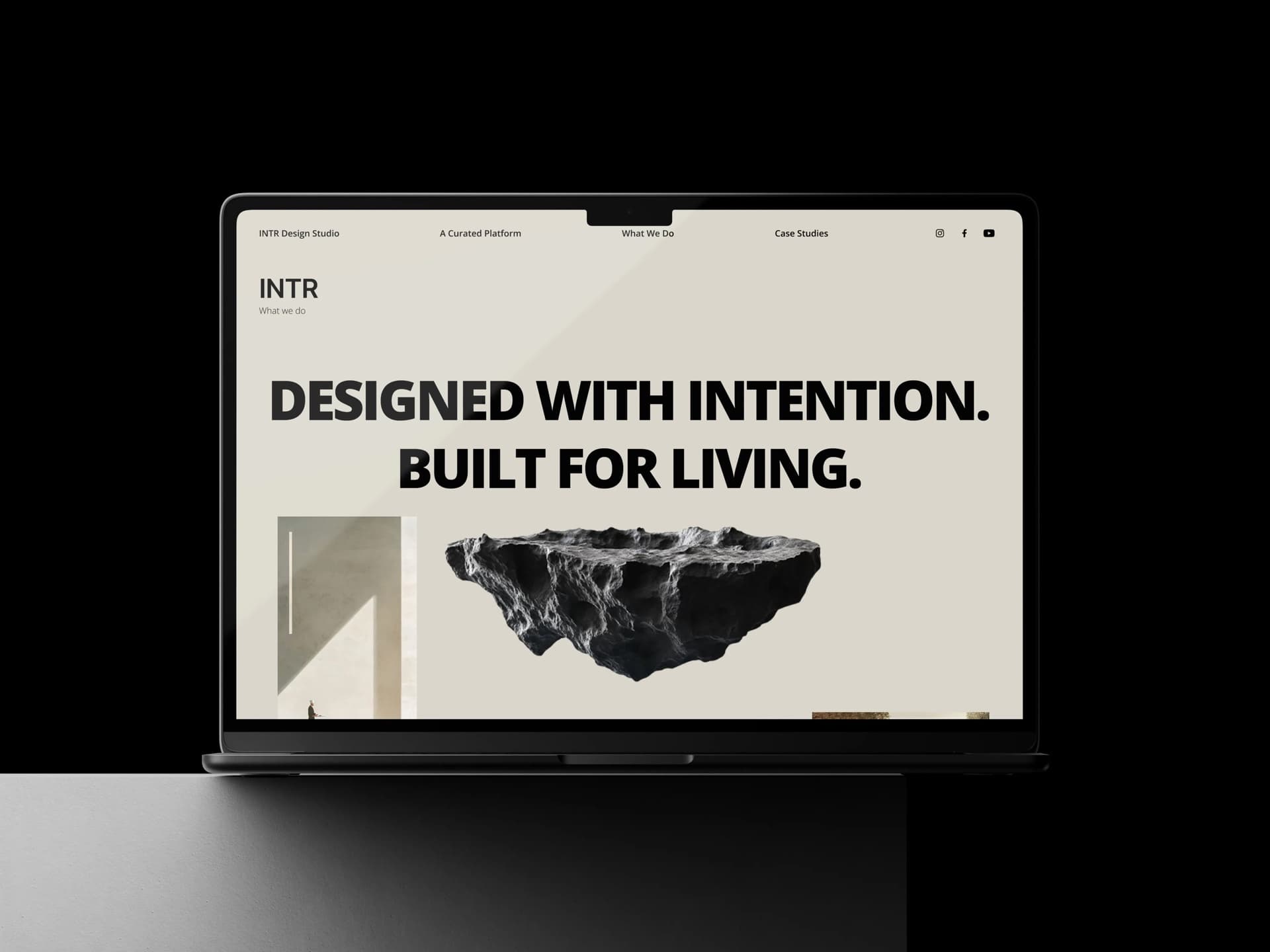 INTR homepage — Designed with Intention, Built for Living — on a dark laptop